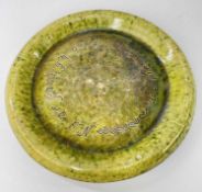 EWENNY POTTERY BREAD PLATE in mottled green glaze, circular, sgraffito inscribed 'Nid ar fara yn