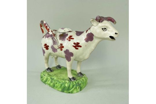 SWANSEA PEARLWARE COW CREAMER, typically decorated with lilac and iron red lustre, standing on a - Image 1 of 3