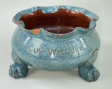 EWENNY POTTERY SHALLOW SEED-PLANTER raised on three paw feet and with lobed rim, in light blue