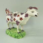 SWANSEA PEARLWARE COW CREAMER, typically decorated with lilac and iron red lustre, standing on a