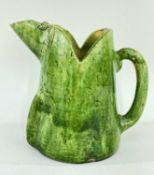 EWENNY POTTERY ZOOMORPHIC JUG IN THE FORM OF A CARICATURE PIG, in a mottled green glaze, 18.5cms