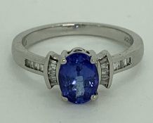 PLATINUM DIAMOND & TANZANITE RHAPSODY RING - 7 x 5mm central stone flanked to the shoulders by