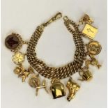 9CT GOLD CHARM BRACELET - with double row curb links and 11 x 9ct gold charms including a swivel fob