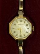 GARRARD & CO LADY'S 9CT GOLD BRACELET WRISTWATCH - in original box with paperwork, the dial set with