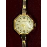 GARRARD & CO LADY'S 9CT GOLD BRACELET WRISTWATCH - in original box with paperwork, the dial set with