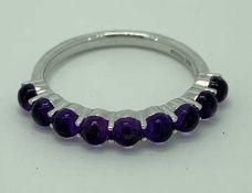 9CT WHITE GOLD & AMETHYST HALF ETERNITY RING - having 9 cabochon claw mounted stones, Size Mid M-