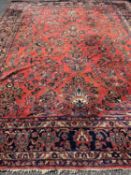 EASTERN WOOLLEN RUG, red ground with exotic floral pattern throughout, 325 x 420cms