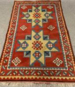 SYMMETRICAL PATTERNED RUG - with red ground, 190cms L, 125cms W