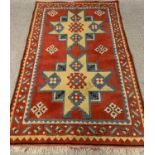 SYMMETRICAL PATTERNED RUG - with red ground, 190cms L, 125cms W