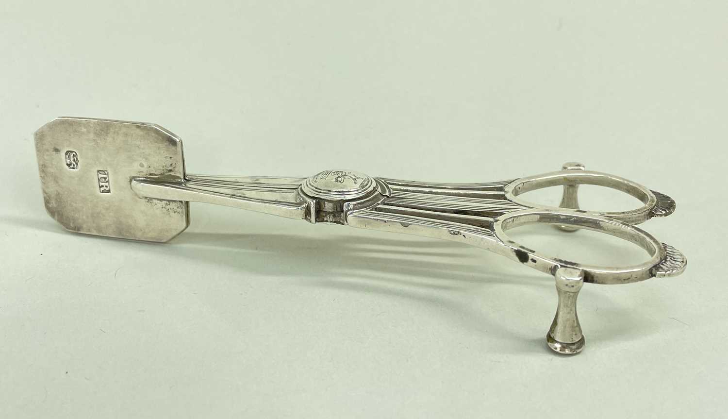 UNUSUAL PAIR GEORGE III CRESTED SILVER CANDLE SNUFFERS, Thomas Radcliffe, London 1817, canted