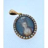 19TH CENTURY OVAL PENDANT ON LOOP, depicting hand-painted portrait of a lady within border of seed