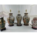 FIVE MODERN ORIENTAL-STYLE TABLE LAMPS, including a set of three, all with white/cream shades and