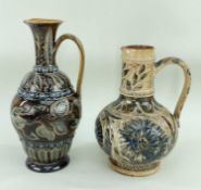 TWO DOULTON LAMBETH EWERS, both decorated with foliate motifs, the tallest having incised