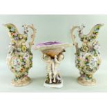 CONTINENTAL PORCELAIN FIGURAL SHELL CENTREPIECE & PAIR EWERS, latter encrusted with flowers and