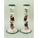 PAIR LLANELLY POTTERY CANDLESTICKS, painted with wild roses, 24cms high (2) Comments: one with