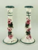 PAIR LLANELLY POTTERY CANDLESTICKS, painted with wild roses, 24cms high (2) Comments: one with