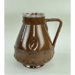 DOULTON LAMBETH SILICON WARE JUG, in the form of a copper finish riveted jack, silver rim, London