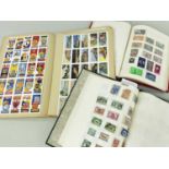 STAMPS & CARDS comprising green album of all world stamps, red album of African stamps and a book of