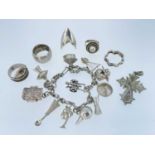 ASSORTED SILVER & WHITE METAL JEWELLERY comprising white metal charm bracelet with various charms,