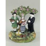 VICTORIAN STAFFORDSHIRE 'TITHE PIG' GROUP, figures standing before a bocage, 15 x 10.5cm Comment: