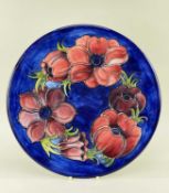 MOORCROFT POTTERY PLAQUE, painted with anemone pattern in red and blue, impressed marks, 30.6cms