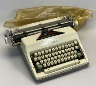 A CIRCA 1960s TYPEWRITER - Olympia SN9 with original vinyl cover