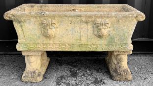 STONEWARE GARDEN FLOWER TROUGH, on twin lion supports and with four lion masks to the body, 90cms