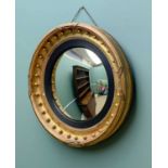 19TH CENTURY GILTWOOD & GESSO CONVEX MIRROR, with ebonised and reeded slip, 59cms diameter Comments: