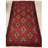 EASTERN STYLE WOOLLEN RUG, red ground with multiple diamond pattern, 182 x 100cms