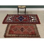 EASTERN RUGS, both red ground, 80 x 126cms and 97 x 191cms together with a VINTAGE UPHOLSTERED