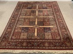 EASTERN RUG, red ground, multiple pattern border and cream cross pattern to the centre, tasselled
