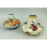 MOORCROFT POTTERY comprising two tube-lined squat vases, one decorated with apricots, dated 96