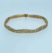 9CT GOLD PANEL BRACELET set with green gems, likely Alexandrites, 20cms long, 9.4gms, in
