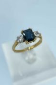 18CT GOLD SAPPHIRE & DIAMOND RING, the central sapphire (8 x 6mms approx.) flanked by two