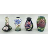 MOORCROFT POTTERY comprising four small tube-lined vases decorated with assorted flowers, birds