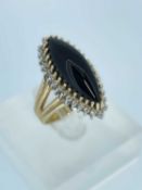 14K GOLD ONYX & DIAMOND CLUSTER RING, the central navette shaped onyx cabochon accented with a
