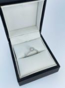 18CT WHITE GOLD DIAMOND CLUSTER RING, of flowerhead design, the central 'Leo Round' diamond