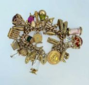 9CT GOLD CURB LINK CHARM BRACELET having heart shaped padlock, approximately thirty charms in mainly