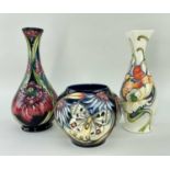 MOORCROFT POTTERY comprising three tube-lined vases including 'Apollo Butterfly' vase, dated