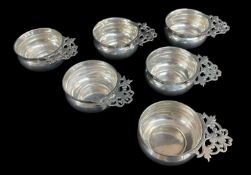 SET OF SIX GEORGE V SILVER TASTE VIN CUPS, of circular squat pot-belly form with pierced handles,