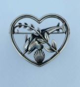 GEORG JENSEN SILVER BROOCH, modelled as a pair of dolphins within a heart shaped border, No 312,
