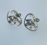 PAIR OF GEORG JENSEN SILVER EARRINGS, modelled as a pair of dolphins within a heart shaped border,