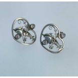 PAIR OF GEORG JENSEN SILVER EARRINGS, modelled as a pair of dolphins within a heart shaped border,