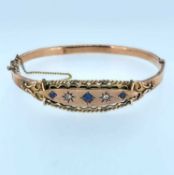 9CT GOLD BANGLE set with three sapphires and two diamonds, 10.0gms, in Crouch of Swansea box