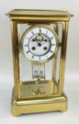 19TH CENTURY FRENCH GILT BRASS MANTEL CLOCK, in a glazed case with white enamel dial and Roman
