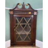 GEORGE III OAK HANGING CORNER CABINET, swan neck pediment with brass mounts and centred with leaf