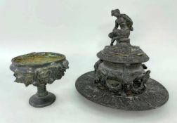 TWO PATINATED BRONZE CLASSICAL STYLE VESSELS, comprising an inkwell with seated satyr finial to