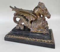 VICTORIAN GILT BRONZE HIPPOCAMPUS DOOR PORTER, on stepped cast iron plinth with applied bronze