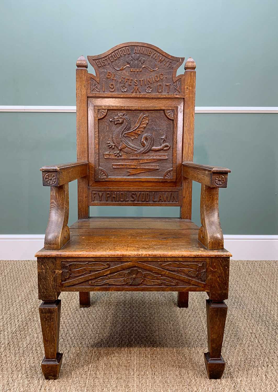 1907 WELSH EISTEDDFOD OAK ARM CHAIR, square panel to back with dragon and inscribed 'Y DDRAIG COCH A
