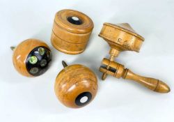 FOUR TURNED FRUITWOOD SPINNING TOPS, three with ebony and mother of pearl/abalone shell inlay, one a